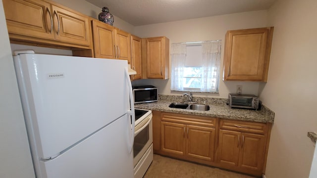 kitchen with a sink, a toaster, and white appliances