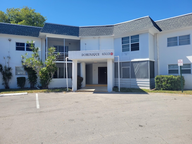 view of property with uncovered parking