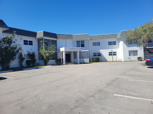 view of building exterior with uncovered parking