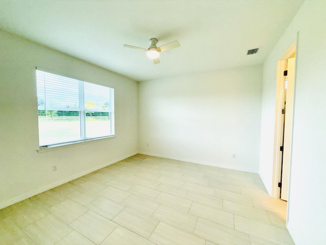 unfurnished room with visible vents, baseboards, and ceiling fan