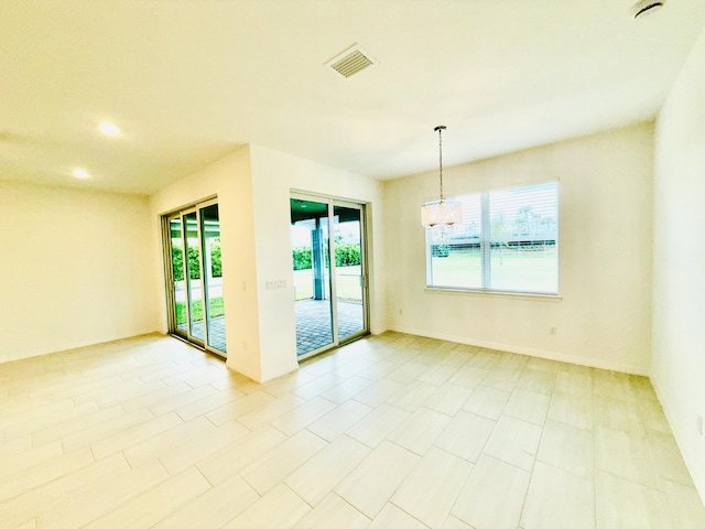 unfurnished room with visible vents and baseboards