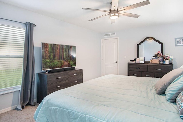 carpeted bedroom featuring a ceiling fan, baseboards, and visible vents