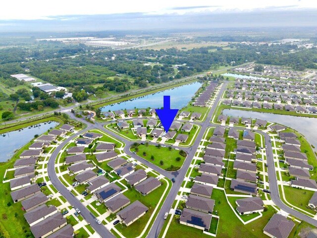 bird's eye view with a residential view and a water view