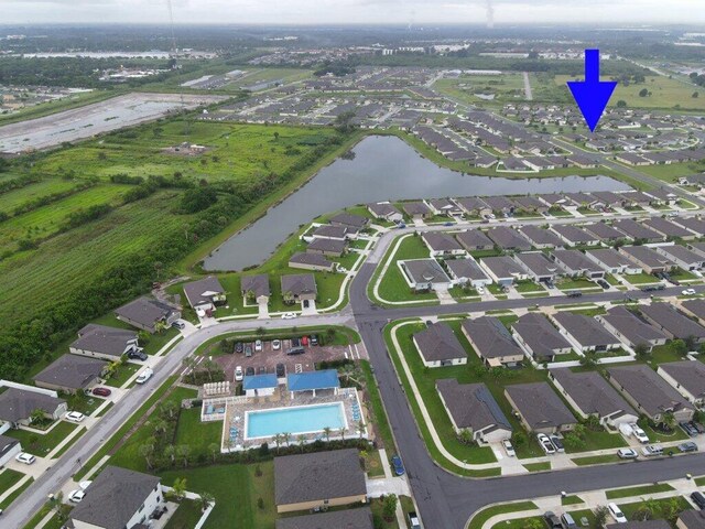 birds eye view of property with a residential view and a water view