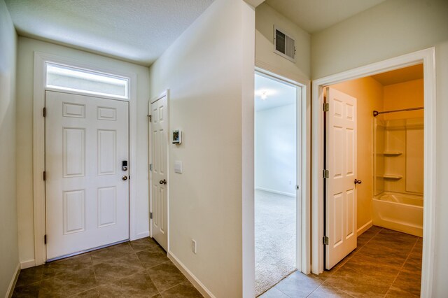 entrance foyer with visible vents and baseboards