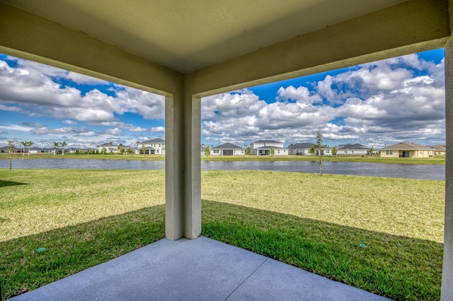 view of patio / terrace featuring a residential view and a water view