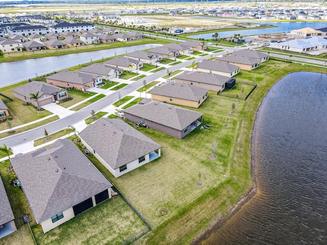 birds eye view of property featuring a residential view and a water view