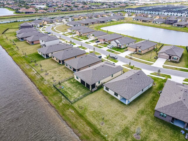 bird's eye view featuring a residential view and a water view