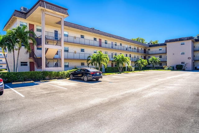 view of property featuring uncovered parking