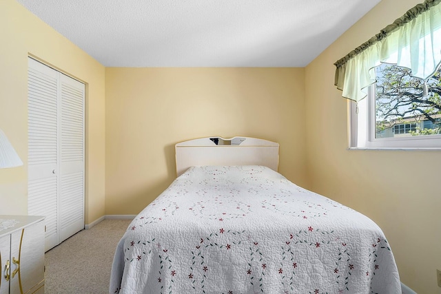 bedroom with a closet, carpet flooring, and baseboards