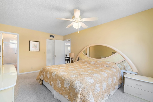 carpeted bedroom with a ceiling fan, baseboards, visible vents, a closet, and a textured ceiling