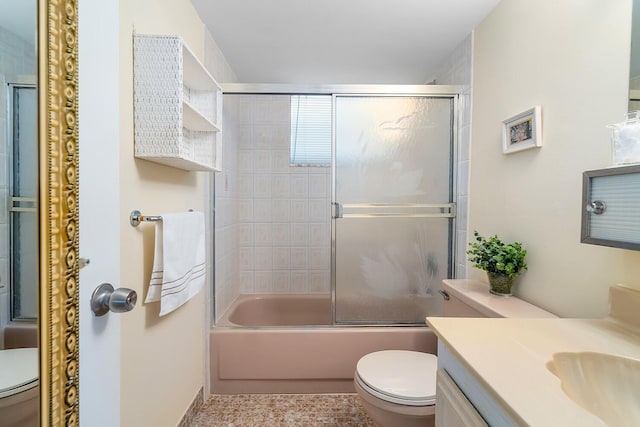 full bathroom with vanity, toilet, and combined bath / shower with glass door