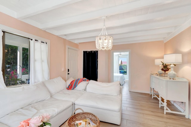 living room with an inviting chandelier, beam ceiling, light wood-style flooring, and baseboards