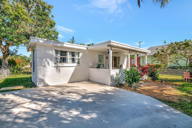 view of front of property featuring stucco siding, fence private yard, and a patio