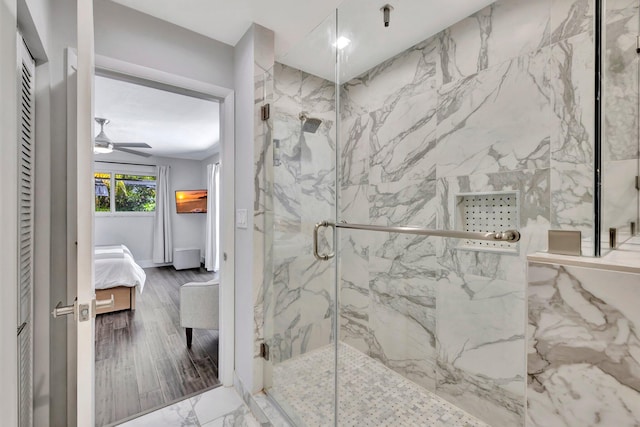 bathroom with a marble finish shower, wood finished floors, ensuite bath, and a ceiling fan