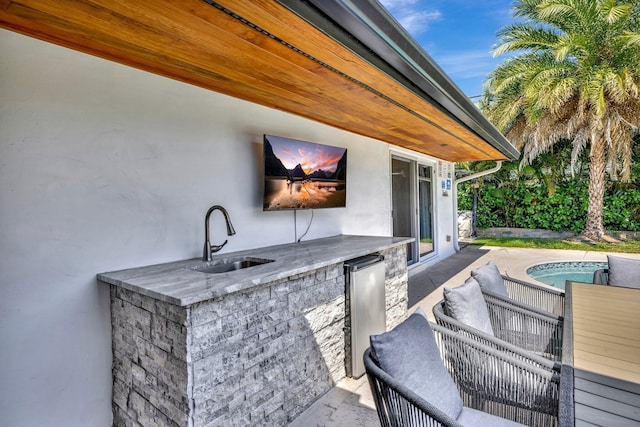 view of patio / terrace featuring a sink and an outdoor pool