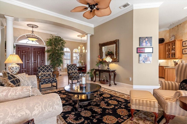 living area with visible vents, ceiling fan, ornamental molding, light tile patterned flooring, and ornate columns