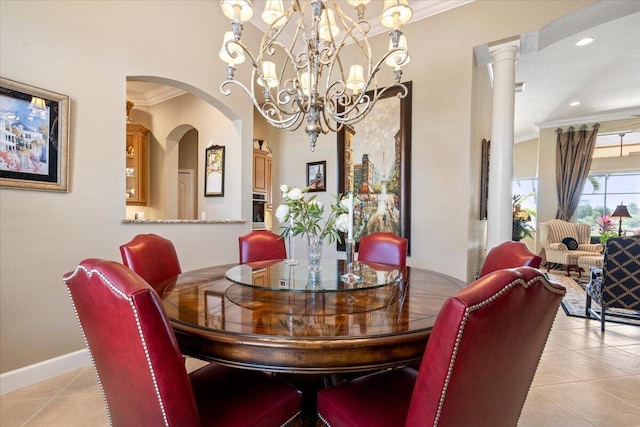 dining space with light tile patterned floors, baseboards, and crown molding