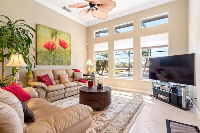 living room with tile patterned floors, visible vents, crown molding, baseboards, and ceiling fan