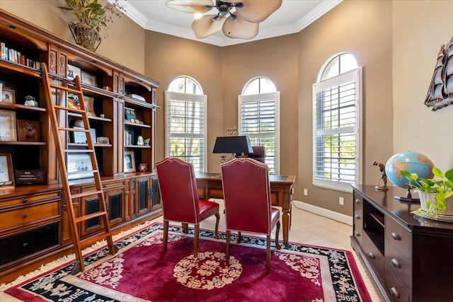 home office with crown molding, light tile patterned floors, a ceiling fan, and baseboards