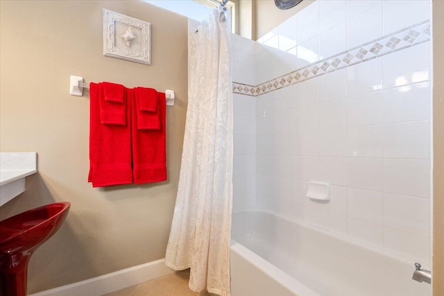 full bathroom featuring baseboards and shower / bath combination with curtain