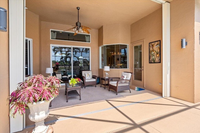 view of patio with an outdoor living space and a ceiling fan