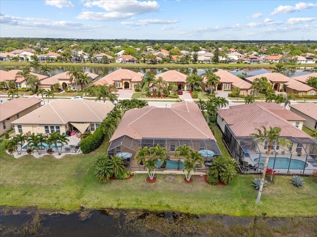 drone / aerial view with a residential view and a water view