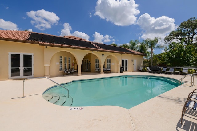 community pool featuring a patio and french doors