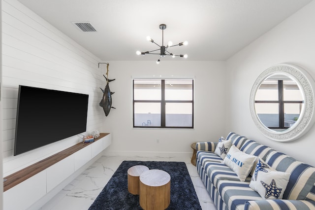 living area featuring a notable chandelier, visible vents, marble finish floor, and a healthy amount of sunlight