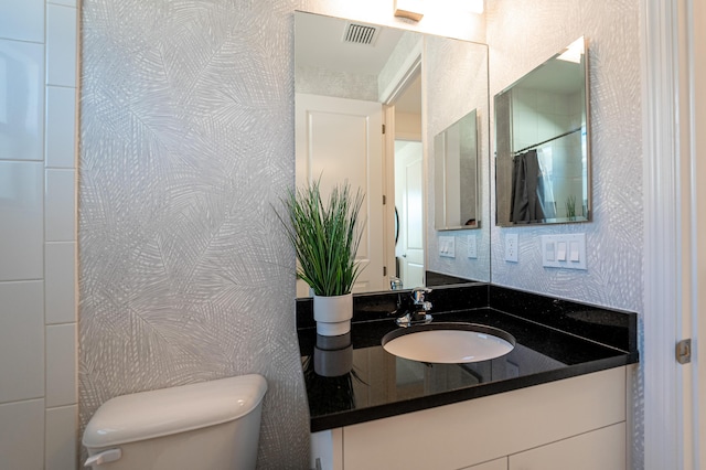 full bath with visible vents, toilet, and vanity