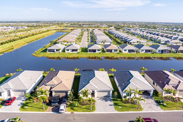 drone / aerial view featuring a residential view and a water view