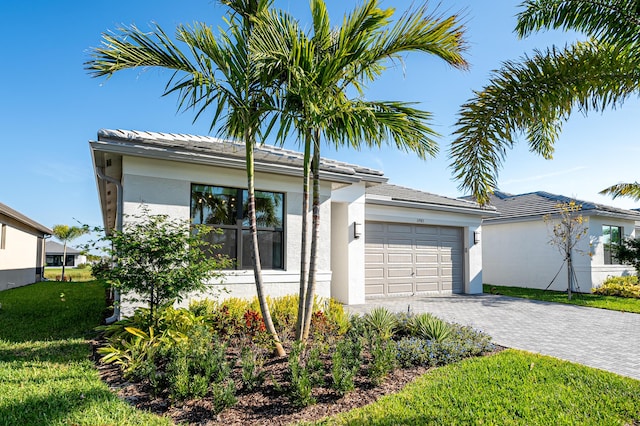 ranch-style house with stucco siding, a front lawn, decorative driveway, and a garage