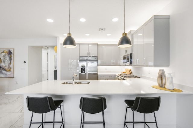 kitchen featuring visible vents, light countertops, appliances with stainless steel finishes, modern cabinets, and a sink