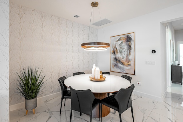 dining area featuring wallpapered walls, baseboards, and marble finish floor