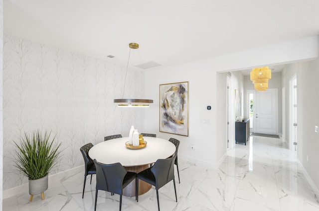 dining space with marble finish floor and baseboards