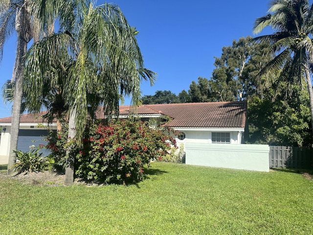 view of yard featuring a garage and fence