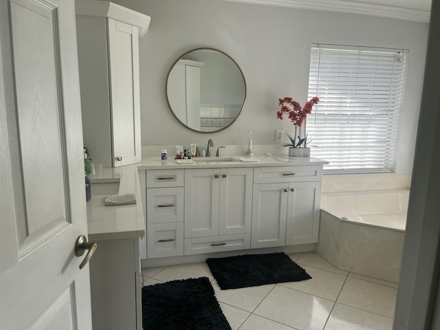 bathroom with a bath, vanity, and tile patterned flooring