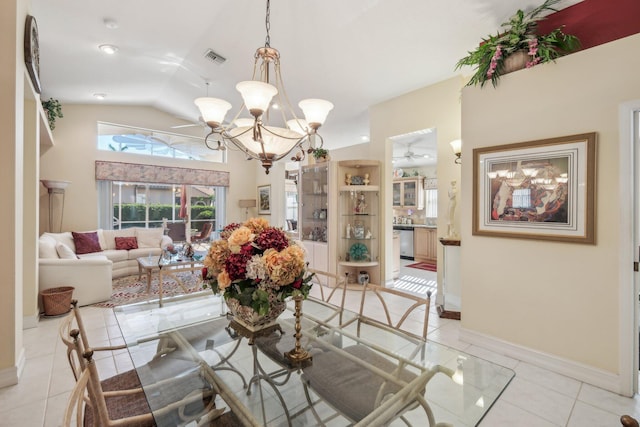 dining space with light tile patterned floors, baseboards, visible vents, an inviting chandelier, and lofted ceiling