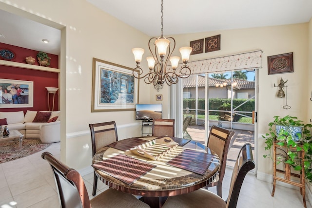 dining room with light tile patterned floors, baseboards, and an inviting chandelier