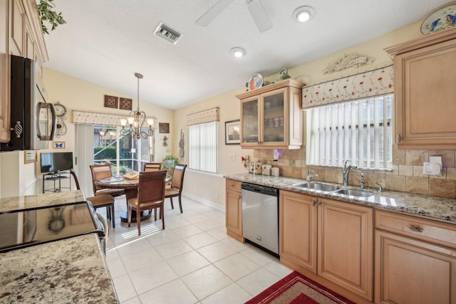 kitchen featuring a sink, lofted ceiling, backsplash, and appliances with stainless steel finishes