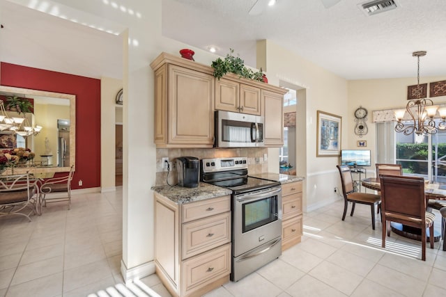 kitchen with visible vents, an inviting chandelier, light tile patterned flooring, stainless steel appliances, and backsplash