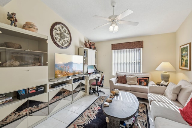 living area with tile patterned flooring, a textured ceiling, lofted ceiling, and a ceiling fan