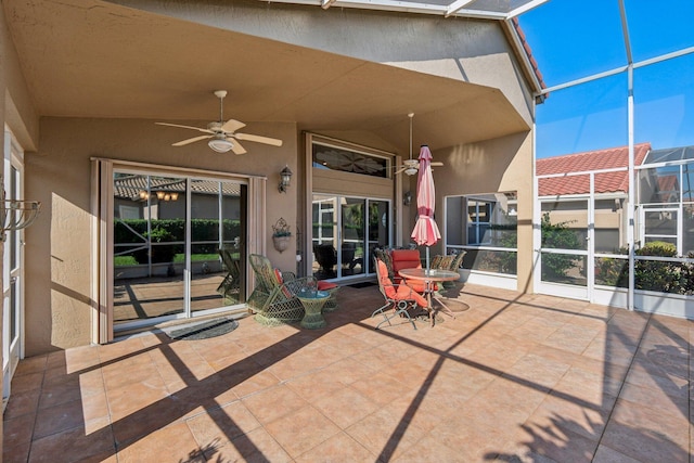 unfurnished sunroom featuring a wealth of natural light, lofted ceiling, and ceiling fan