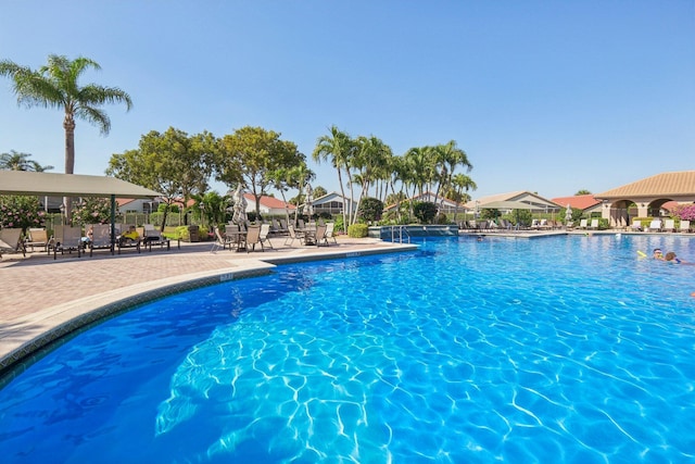 community pool featuring a patio and fence