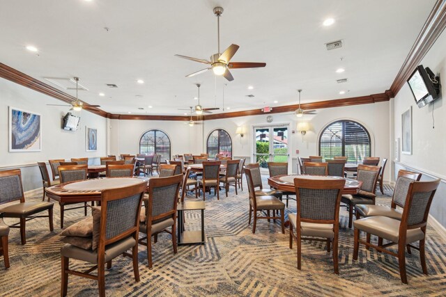 dining room with crown molding, a ceiling fan, and visible vents