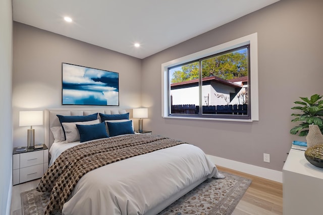 bedroom featuring recessed lighting, baseboards, and light wood finished floors