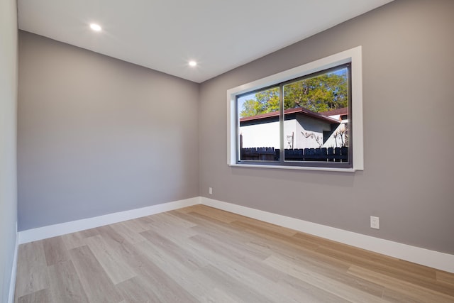 unfurnished room featuring recessed lighting, baseboards, and wood finished floors