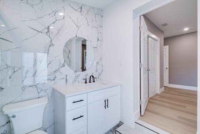 bathroom with vanity, wood finished floors, visible vents, recessed lighting, and toilet