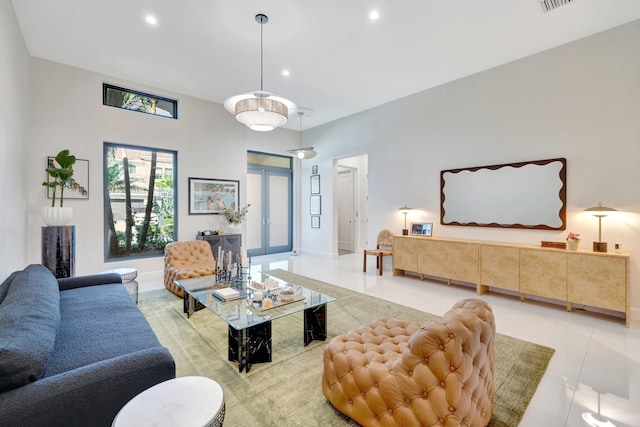 living room featuring light tile patterned flooring, recessed lighting, visible vents, and baseboards