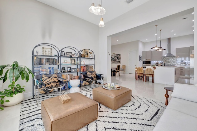 living room featuring light tile patterned flooring, recessed lighting, and baseboards